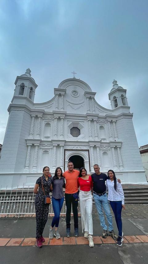 A group in front of a white church