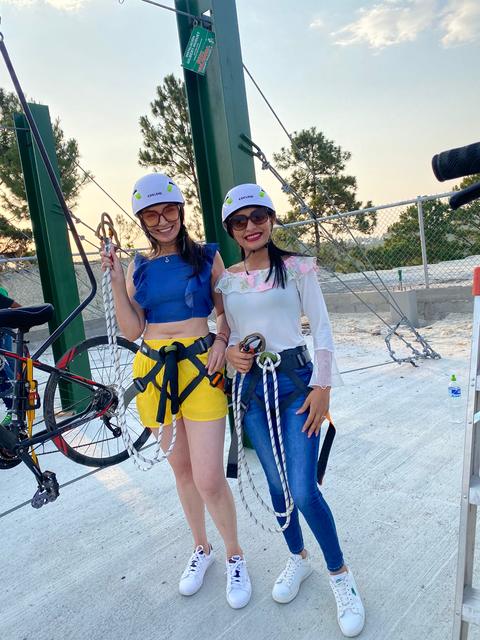 Two people with helmets and harnesses
