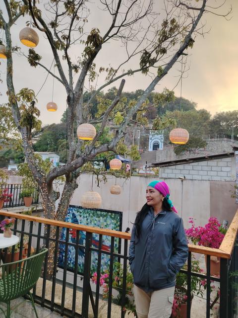A guide on a terrace with lanterns