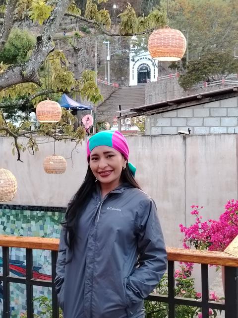 A guide on a terrace with flowers