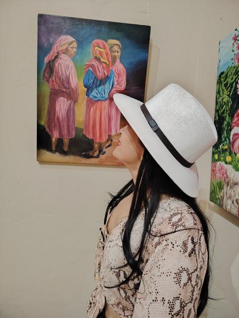 A visitor looking at a painting