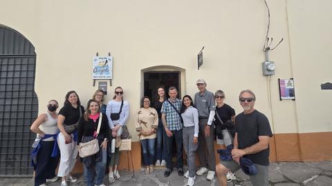 A group in front of a house