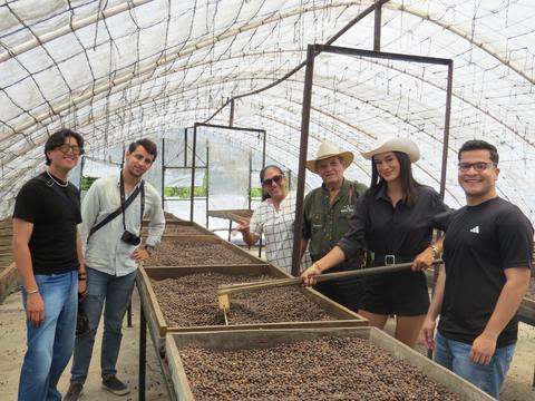 A group in a coffee greenhouse