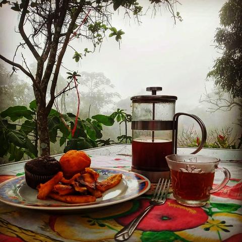 Coffee and bread on a table with a view
