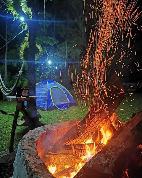 A campfire beside a tent