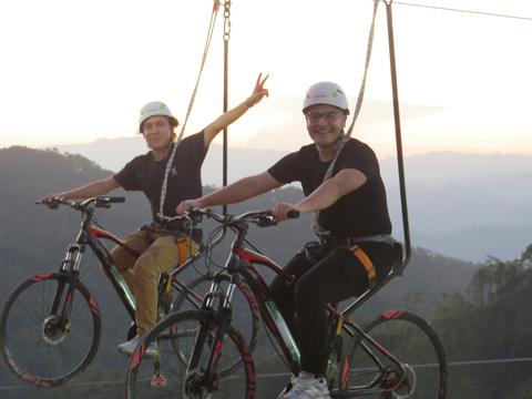 Two people on cable bikes