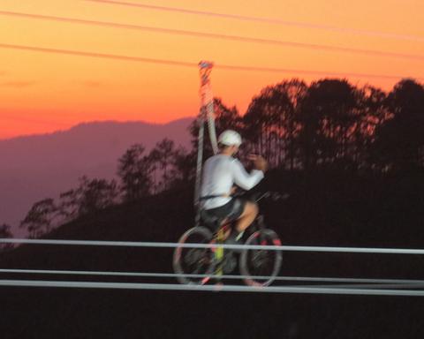 A cable bike under an orange sky