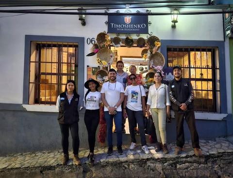 A group in front of a colonial house