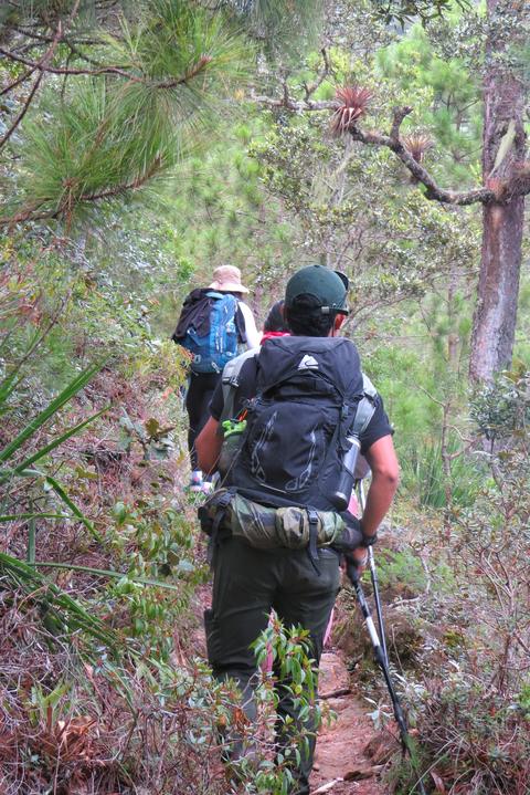 A hiker with a backpack on a trail