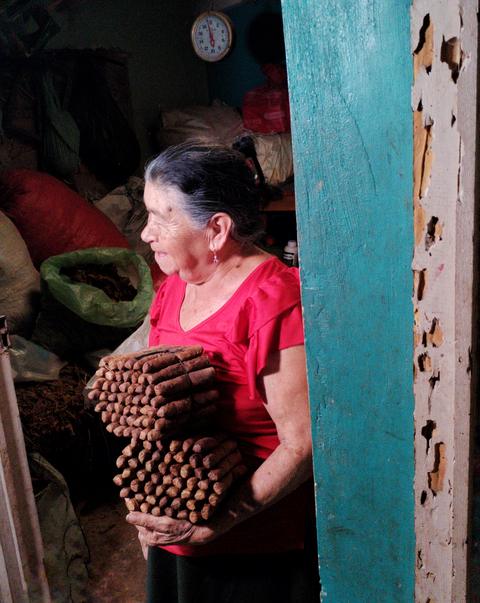 A woman showing handmade cigars