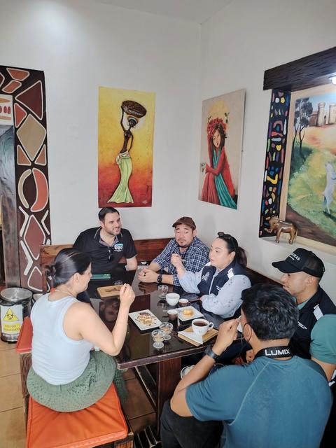 A group at a table with art on the walls