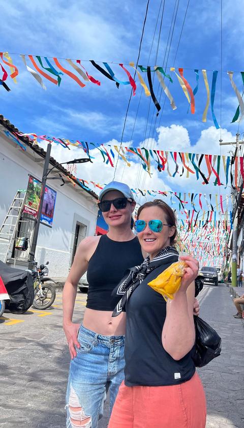 Two travellers on a street with bunting