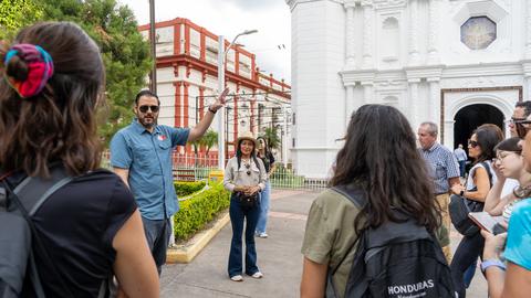 A group in a square in front of a church